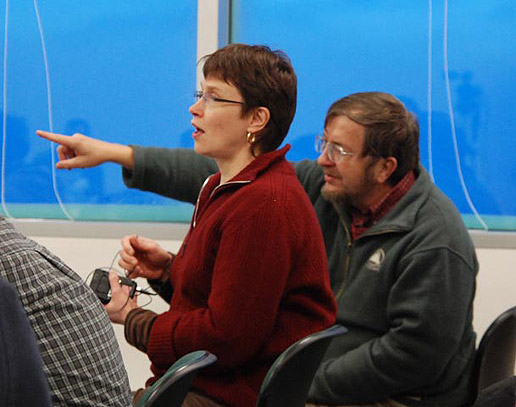 Dr. John F. Cooper, NASA,  and Dr. Kirsti Kauristie, Finnish Meteorological Institute, Helsinki Finland, discuss some of the science presentations. Photo Credit - Jay Friedlander